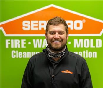 Man in front of SERVPRO logo